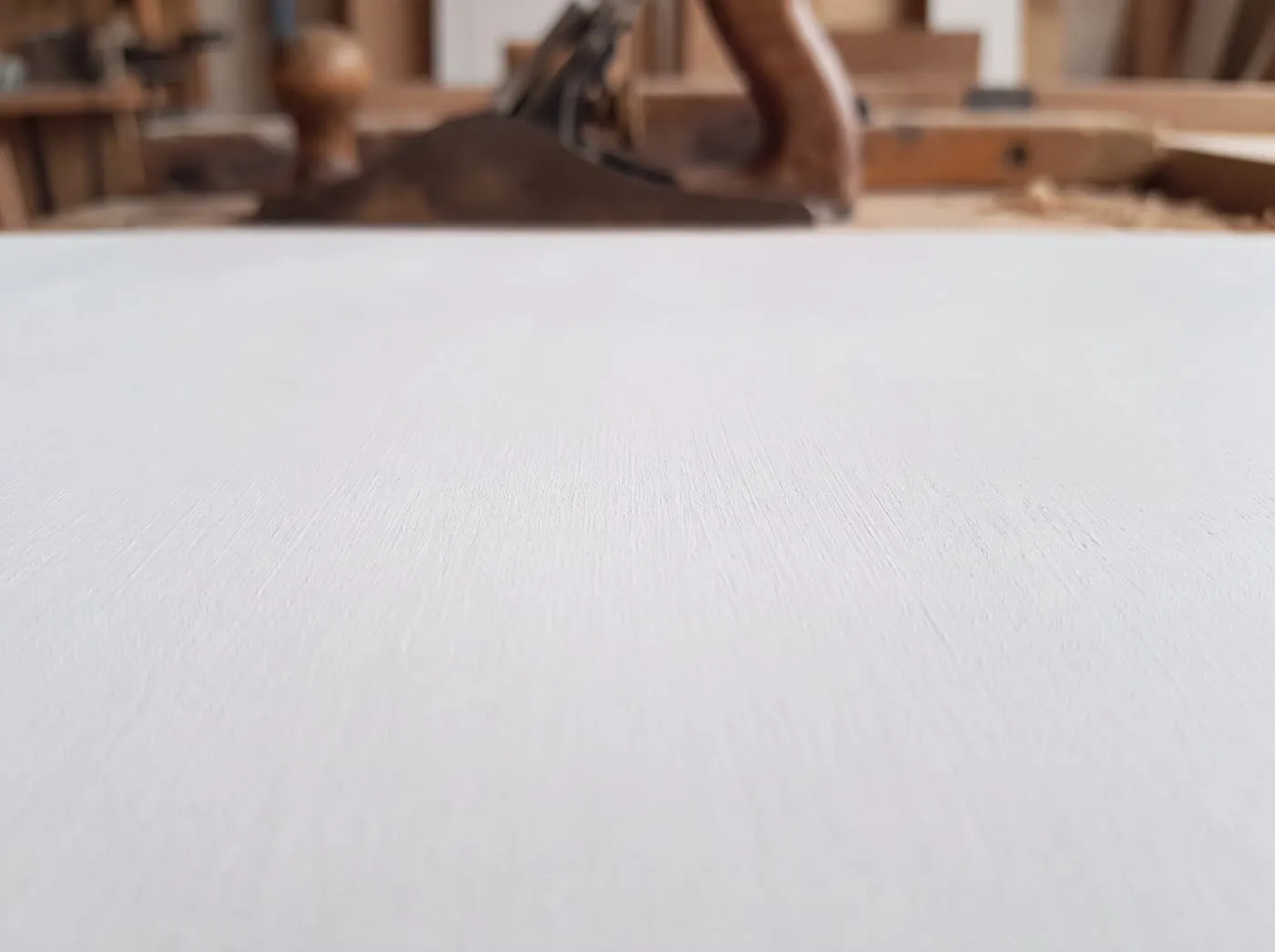 A macro study of a white primed panel, faint brush texture in the primer